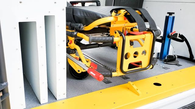spine board storage area and oxygen bottle holders inside medical van