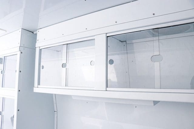 Slide-to-open aluminum cabinets in the Mobile Mitigation van (MM Model) used for overdose prevention.