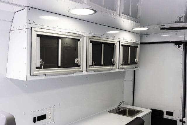 Optional lockable upper cabinets in MoveMobility Outreach Van