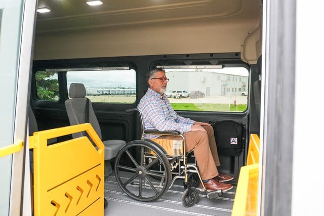 man in wheelchair sitting in a side entry accessible van from MoveMobility