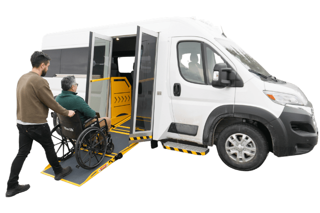 Man pushing wheelchair user into P4 van from MoveMobility
